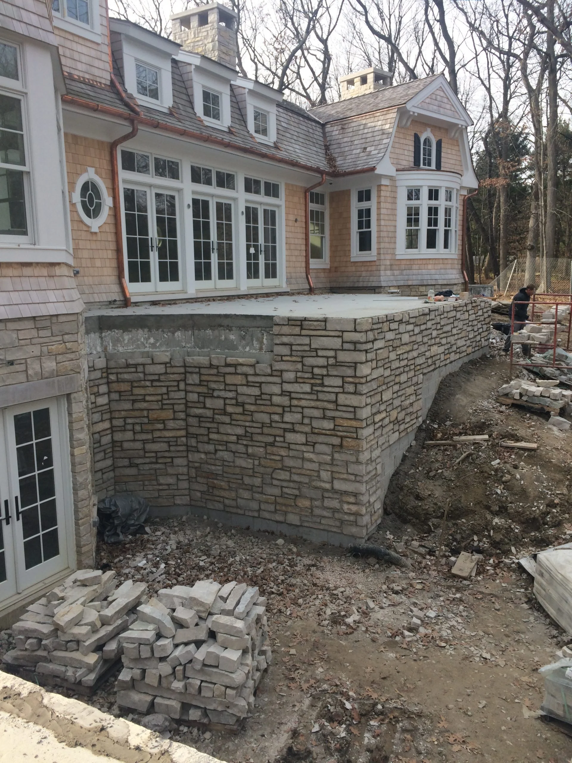Professional masonry restoration near me repairing stonework on residential home.