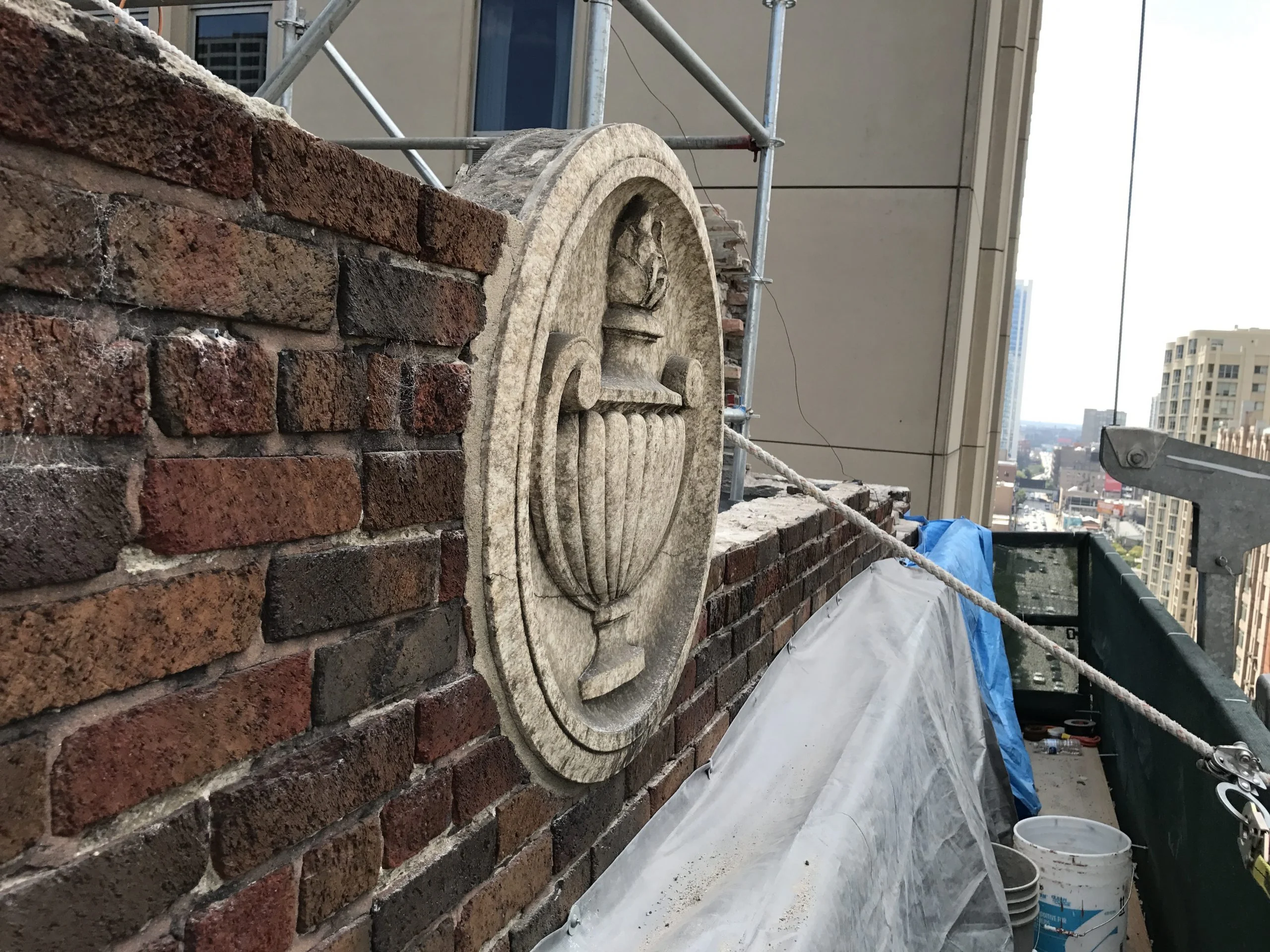 Experienced stonemason carefully carving intricate stone details for a new project.